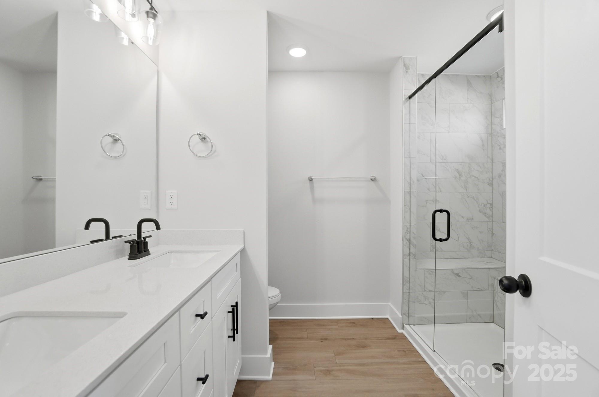 406 Limelight Road Waxhaw, NC 28173 - Photo 33 of 48 a bathroom with a tub sink and mirror