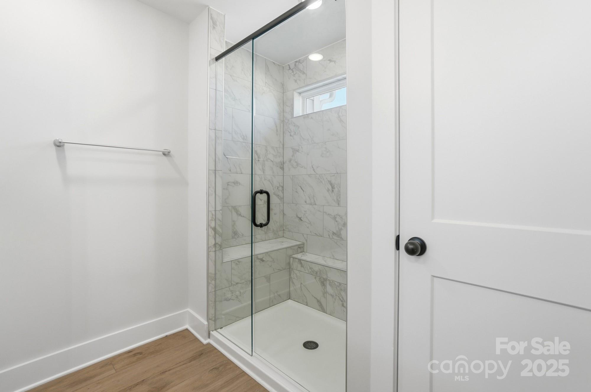 406 Limelight Road Waxhaw, NC 28173 - Photo 34 of 48 a bathroom with a glass shower door