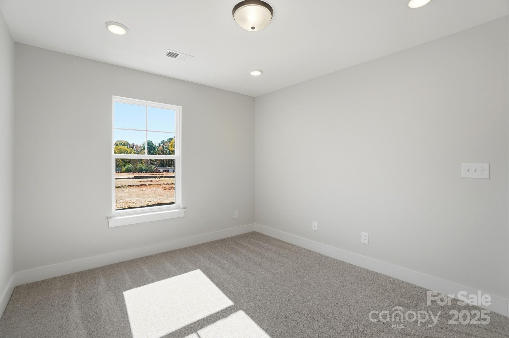 406 Limelight Road Waxhaw, NC 28173 - Photo 36 of 48 an empty room with windows