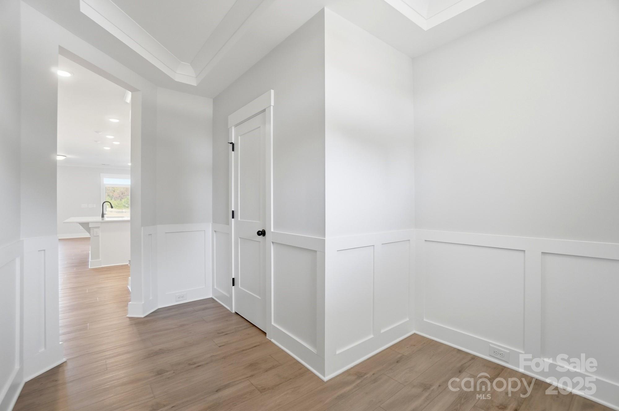 406 Limelight Road Waxhaw, NC 28173 - Photo 4 of 48 a view of a hallway with wooden floor