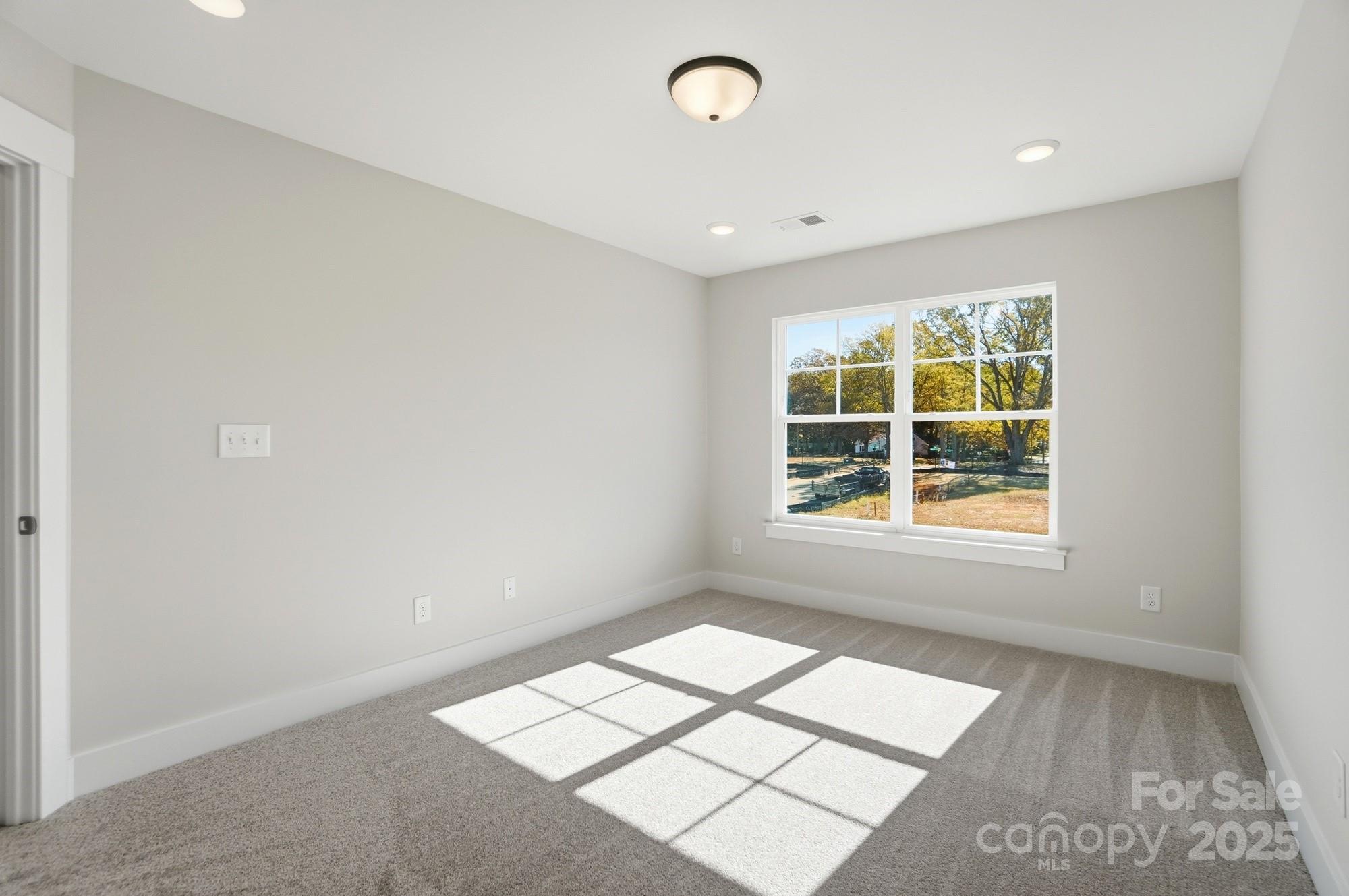 406 Limelight Road Waxhaw, NC 28173 - Photo 41 of 48 an empty room with windows