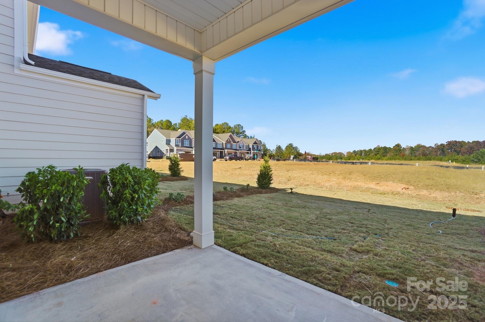406 Limelight Road Waxhaw, NC 28173 - Photo 43 of 48 a view of a lake with a yard
