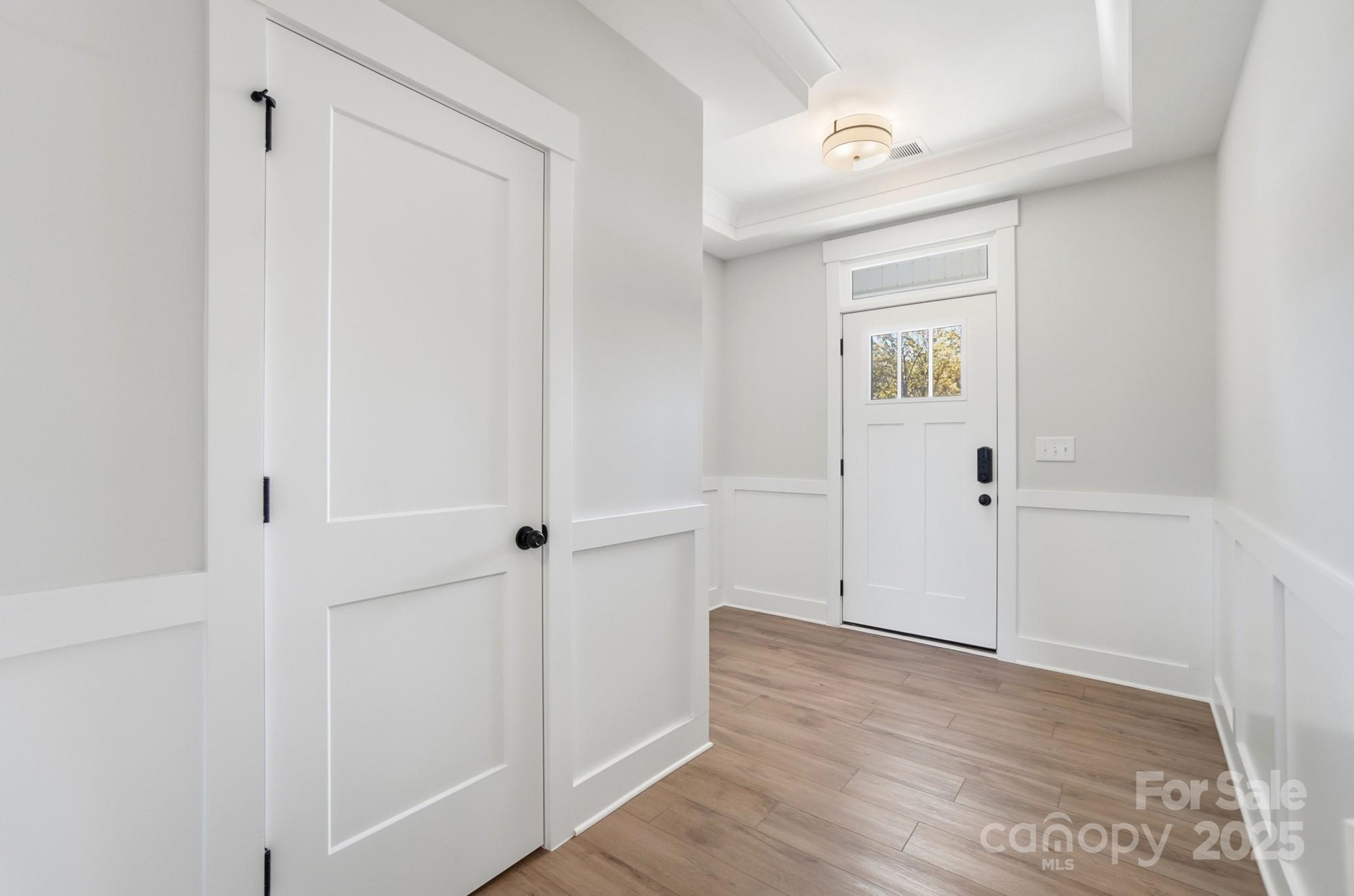 406 Limelight Road Waxhaw, NC 28173 - Photo 5 of 48 a view of a hallway with wooden floor