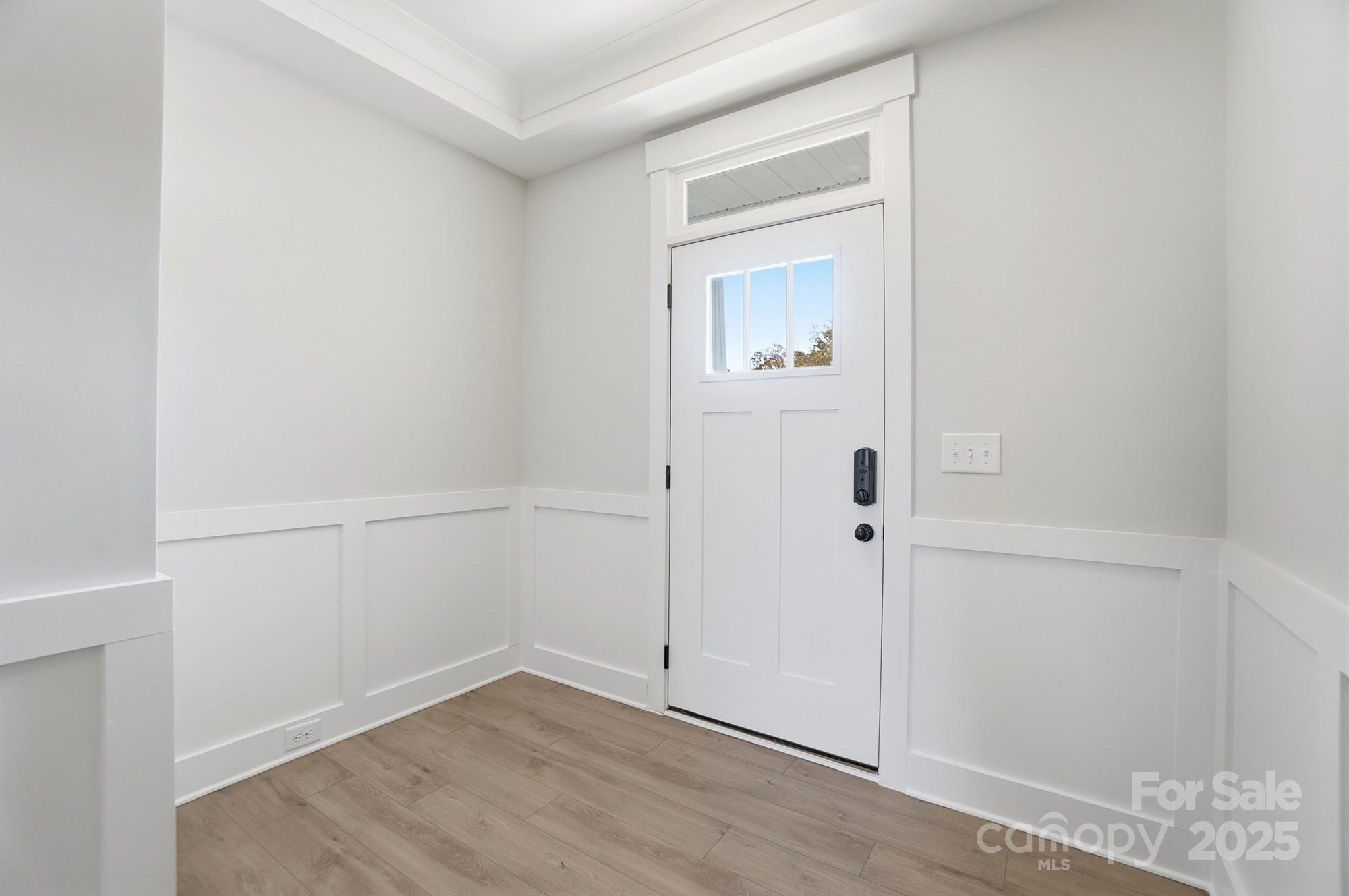 406 Limelight Road Waxhaw, NC 28173 - Photo 6 of 48 an empty room with wooden floor and mirror