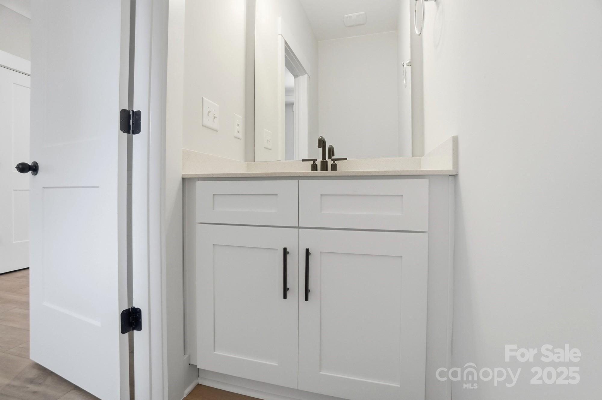406 Limelight Road Waxhaw, NC 28173 - Photo 9 of 48 a bathroom with a sink and mirror