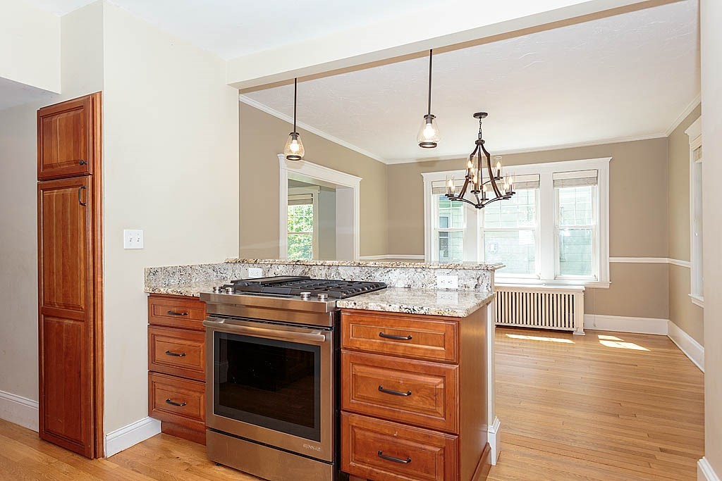 37 Huntington Road Milton, MA 02186 - Photo 16 of 35 a kitchen with a stove and wooden floor
