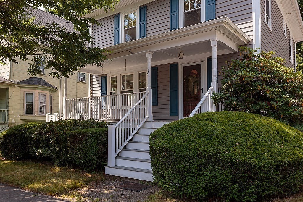 37 Huntington Road Milton, MA 02186 - Photo 2 of 35 a view of a house with brick walls and a yard in front of it