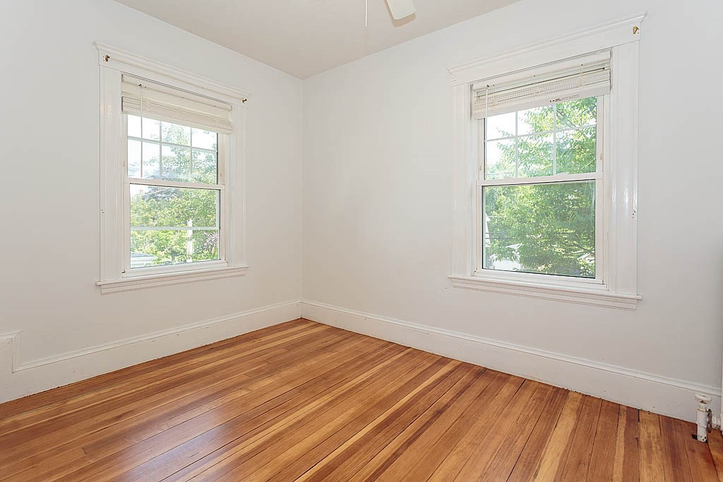 37 Huntington Road Milton, MA 02186 - Photo 25 of 35 a view of an empty room with wooden floor and a window
