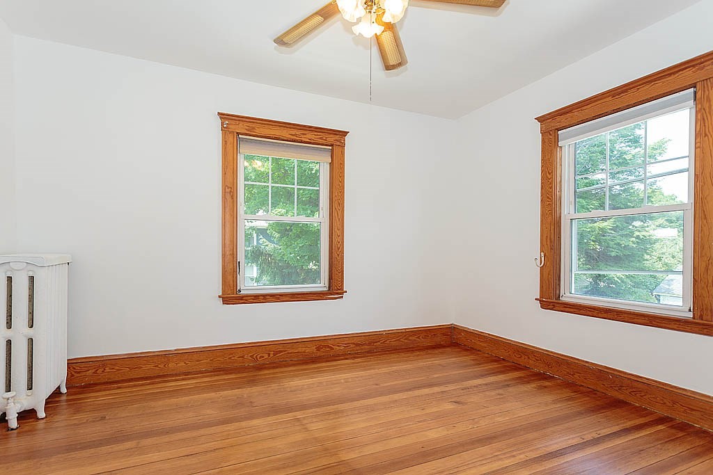 37 Huntington Road Milton, MA 02186 - Photo 26 of 35 a view of an empty room with wooden floor and a window