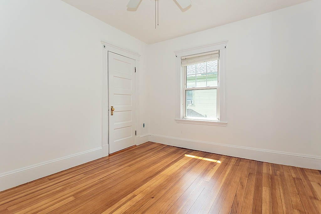 37 Huntington Road Milton, MA 02186 - Photo 27 of 35 an empty room with wooden floor and windows