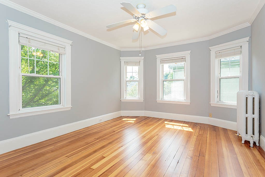 37 Huntington Road Milton, MA 02186 - Photo 30 of 35 a view of an empty room with wooden floor and a window
