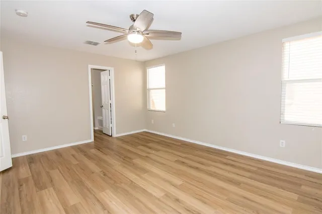 wooden floor in an empty room with a window