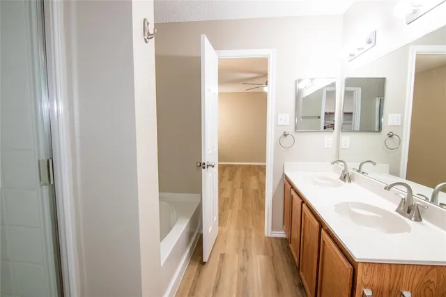 a bathroom with a sink a mirror and a shower