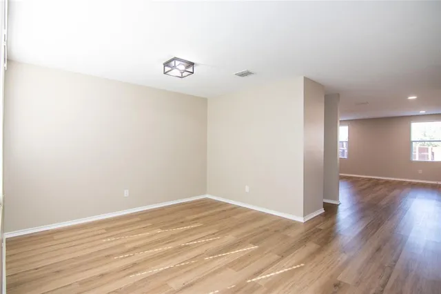 a view of a room with wooden floor and window