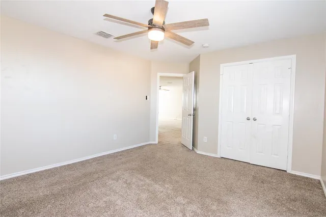 an empty room with fan and a ceiling fan