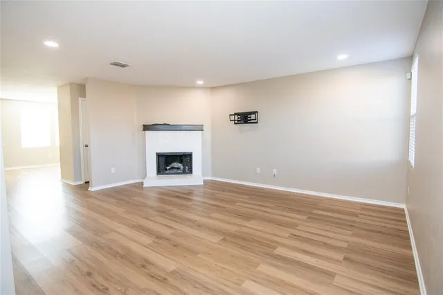 wooden floor in an empty room with a fireplace