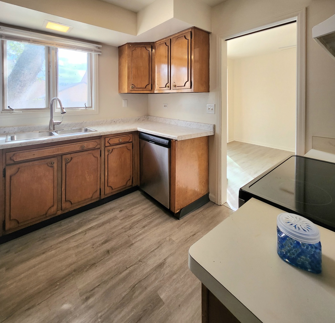 768 Concord Lane, Unit 768 Barrington, IL 60010 - Photo 2 of 12 a kitchen with stainless steel appliances granite countertop a sink a stove and a wooden floors