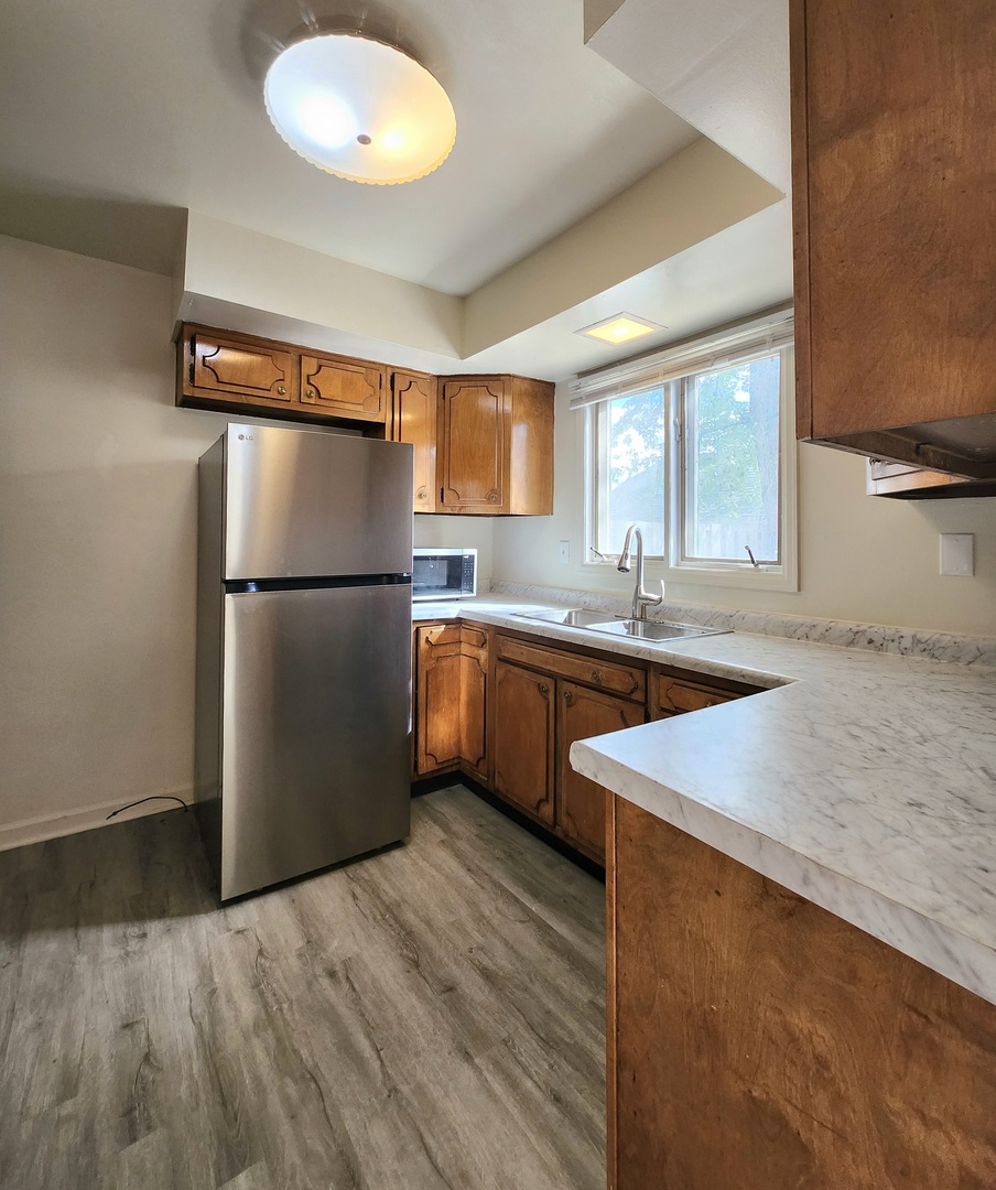 768 Concord Lane, Unit 768 Barrington, IL 60010 - Photo 5 of 12 a kitchen with stainless steel appliances granite countertop a sink stove and refrigerator