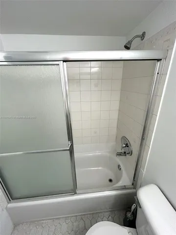 a bathroom with a bathtub and a toilet