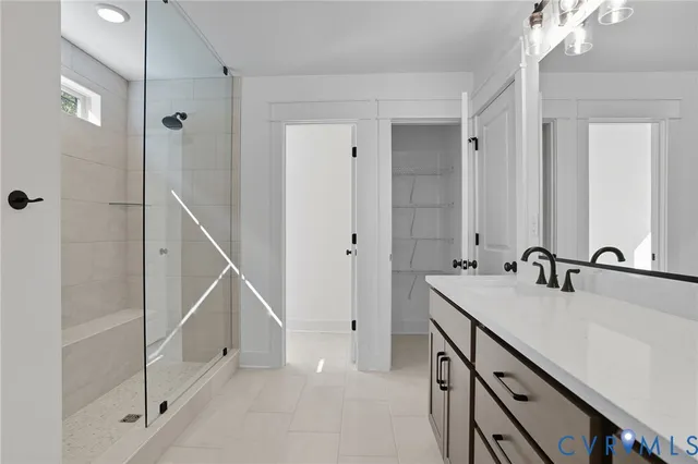 a bathroom with a double vanity sink and mirror with shower