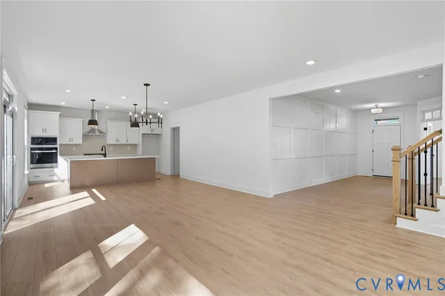 a kitchen with stainless steel appliances a sink a stove and a wooden floors
