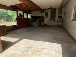 a view of a porch with a table and chairs