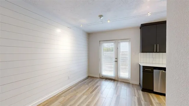 a view of empty room with wooden floor and fireplace