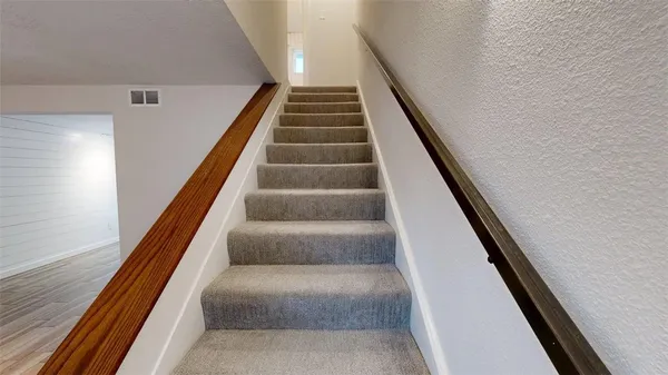 a view of staircase with white walls