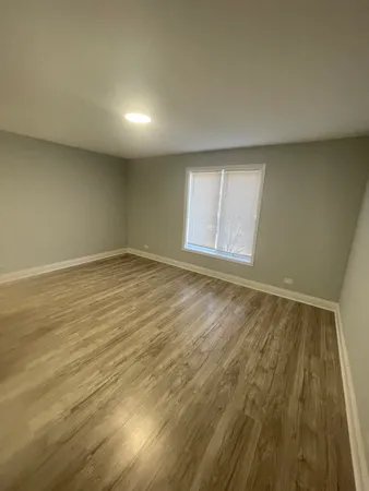 a view of an empty room and wooden floor