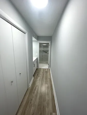 a view of hallway with wooden floor
