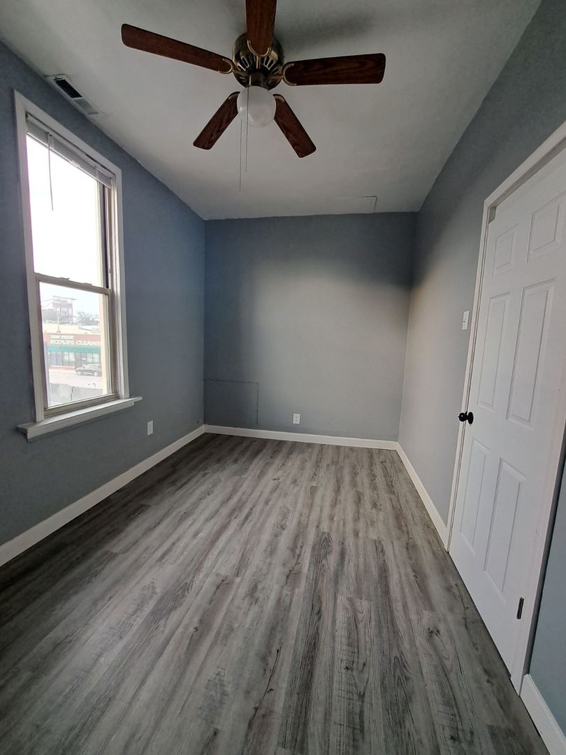 3128 North Clybourn Avenue, Unit 2R Chicago, IL 60618 - Photo 14 of 33 wooden floor in an empty room with a window