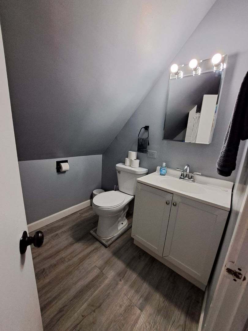 3128 North Clybourn Avenue, Unit 2R Chicago, IL 60618 - Photo 18 of 33 a bathroom with a sink mirror and toilet