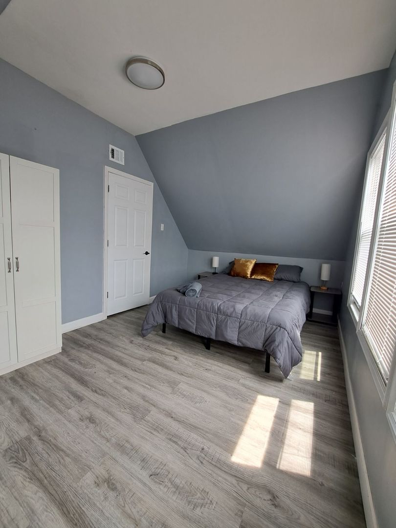 3128 North Clybourn Avenue, Unit 2R Chicago, IL 60618 - Photo 22 of 33 a view of a bedroom with wooden floor and furniture