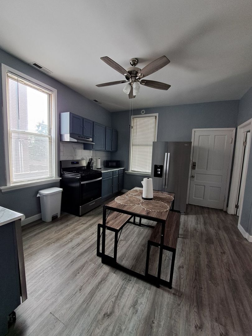 3128 North Clybourn Avenue, Unit 2R Chicago, IL 60618 - Photo 3 of 33 a living room with stainless steel appliances furniture wooden floor and a window