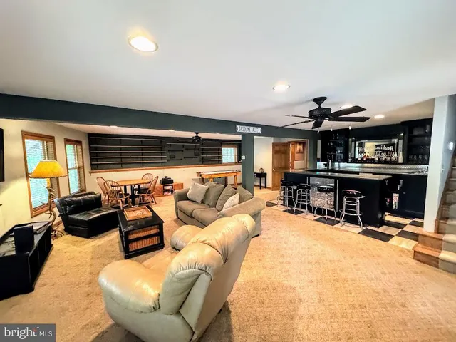 a room with furniture a flat screen tv and a view of living room