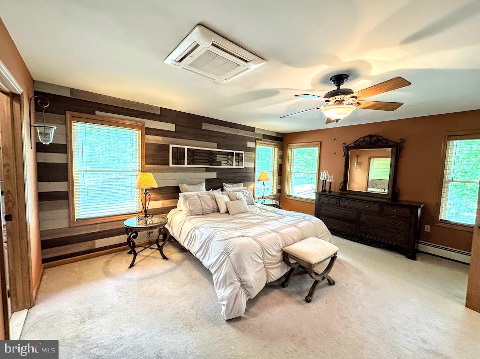 64 Algonquin Drive Hazleton, PA 18202 - Photo 22 of 64 a bedroom with a large bed and a chandelier