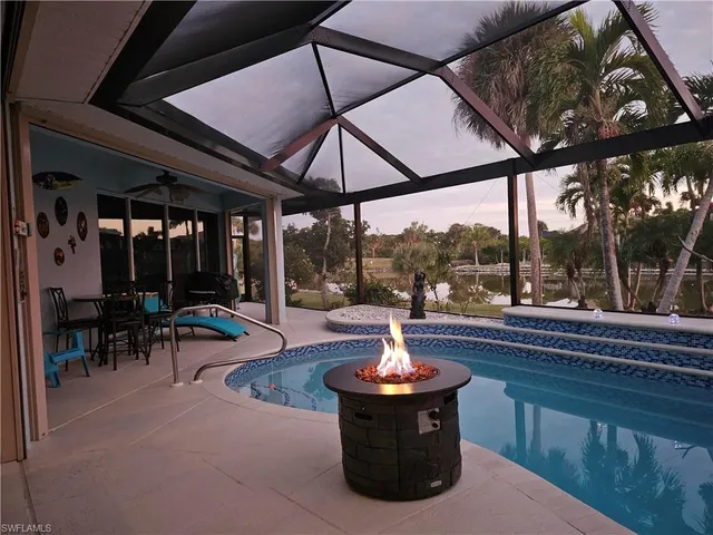 a view of a chairs and table in the patio in front of a house