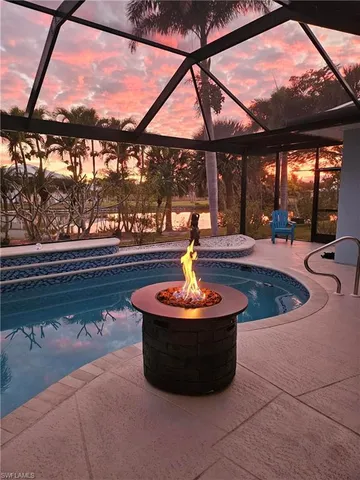 a living room with large windows and a table
