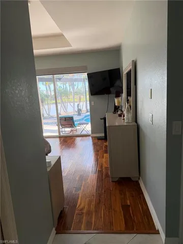 a view of a living room and a hardwood floor