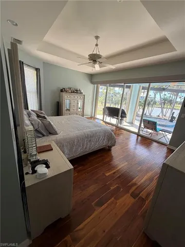 a bedroom with furniture and a large window
