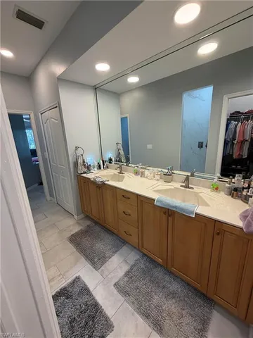 a bathroom with a double vanity sink and a mirror