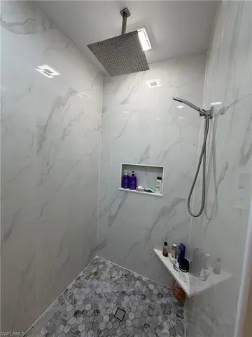 a bedroom with a bed and a potted plant