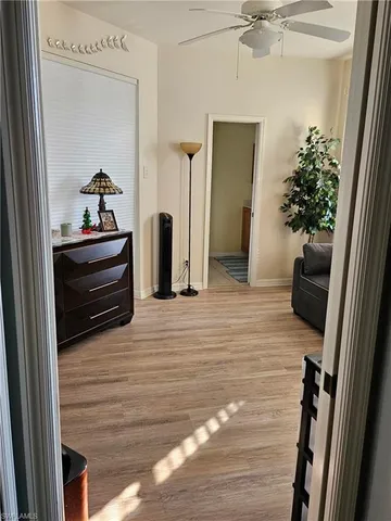 a room with a bed and large windows