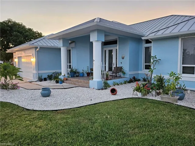 a view of a house with backyard and sitting area