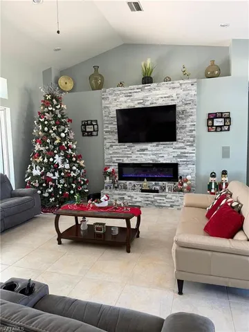 a large kitchen with kitchen island a sink a stove a refrigerator and a dining table with wooden floor