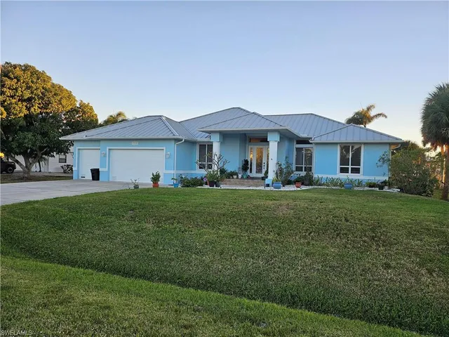 a front view of a house with a garden