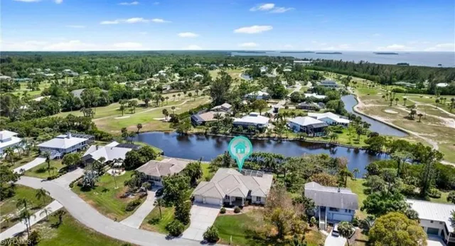 an aerial view of lake and residential houses with outdoor space