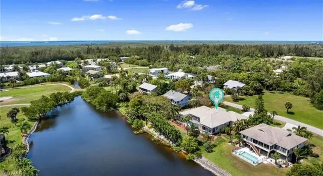 an aerial view of a house with a garden and lake view