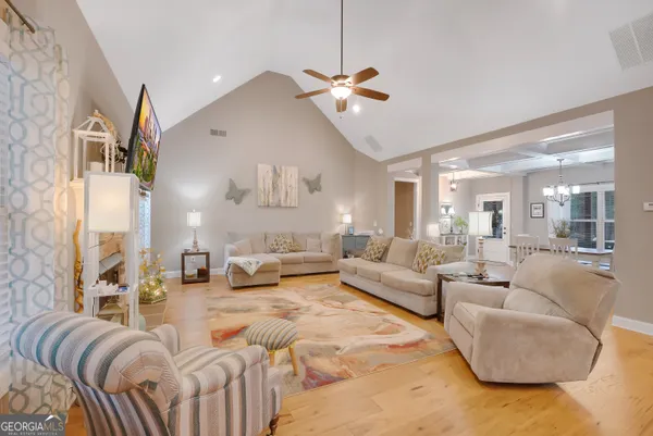 a living room with furniture and a chandelier