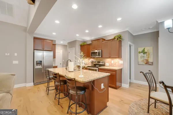 a large kitchen with a table and chairs